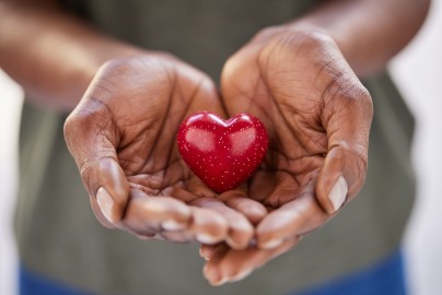 Close up of black woman hands holding a small red heart. Small heart in the hands of a african woman. Solidarity, charity and responsibility concept. Close up of black woman hands holding a small red heart. Small heart in the hands of a african woman. Solidarity, charity and responsibility concept.